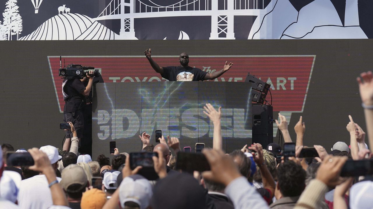 Former NBA player Shaquille O'Neal, , top center, a.k.a. DJ Diesel, performs after a NASCAR Cup Series auto race at Sonoma Raceway, Sunday, June 11, 2023, in Sonoma, Calif. (AP Photo/Darren Yamashita)