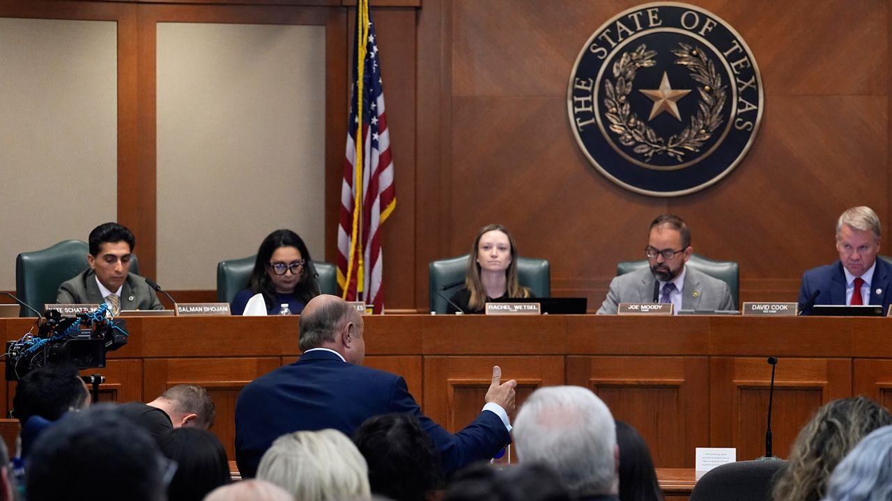 Dr. Phil McGraws, in blue suit gesturing with hand, makes comments during a committee hearing in the case of death row inmate Robert Roberson, Monday, Oct. 21, 2024, in Austin, Texas. (AP Photo/Tony Gutierrez)