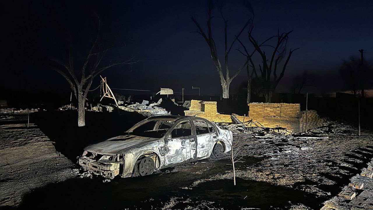 A charred vehicle sits near the ruins of a home after the property was burned by the Smokehouse Creek Fire, Wednesday, Feb. 28, 2024, in Fritch, Texas. (AP Photo/Ty O'Neil)