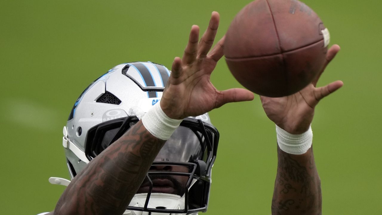 Carolina Panthers running back Miles Sanders reacts for a catch during the NFL football team's training camp in Charlotte, N.C., Sunday, Aug. 4, 2024. (AP Photo/Chuck Burton)