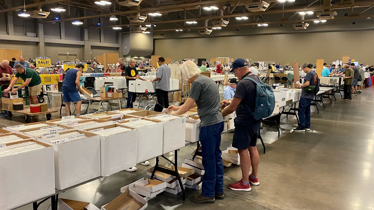 Early shoppers sift through boxes and crates of vinyl on opening day of the Austin Record Convention.