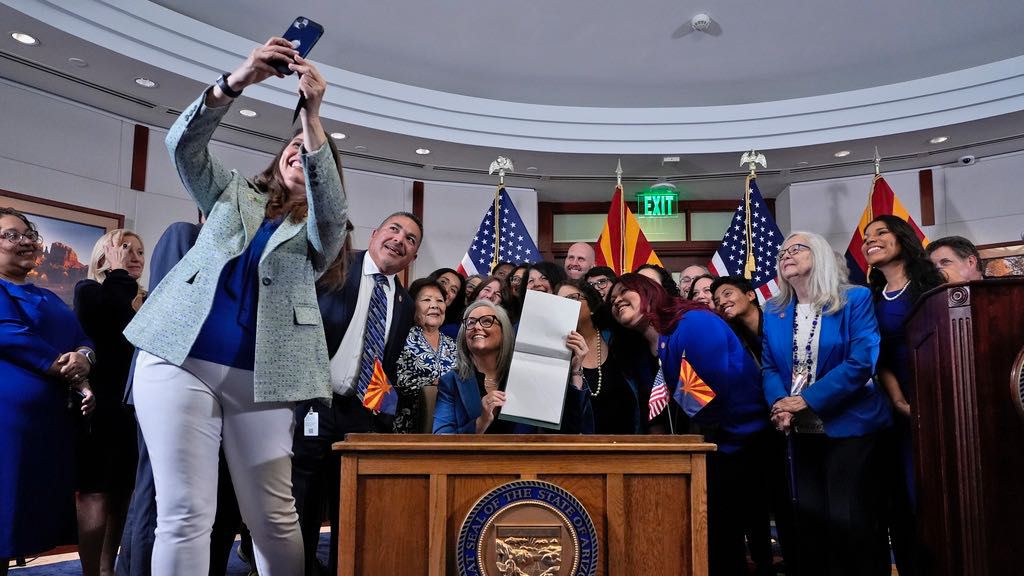 Arizona Rep. Stephanie Stahl Hamilton takes a selfie with Arizona Gov. Katie Hobbs after Hobbs signed the repeal of the Civil War-era near-total abortion ban on May 2, 2024, at the state Capitol in Phoenix. (AP Photo/Matt York, File)