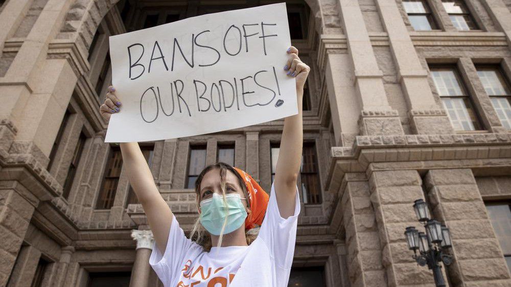 Protester holding up sign at abortion protest. (AP Images)