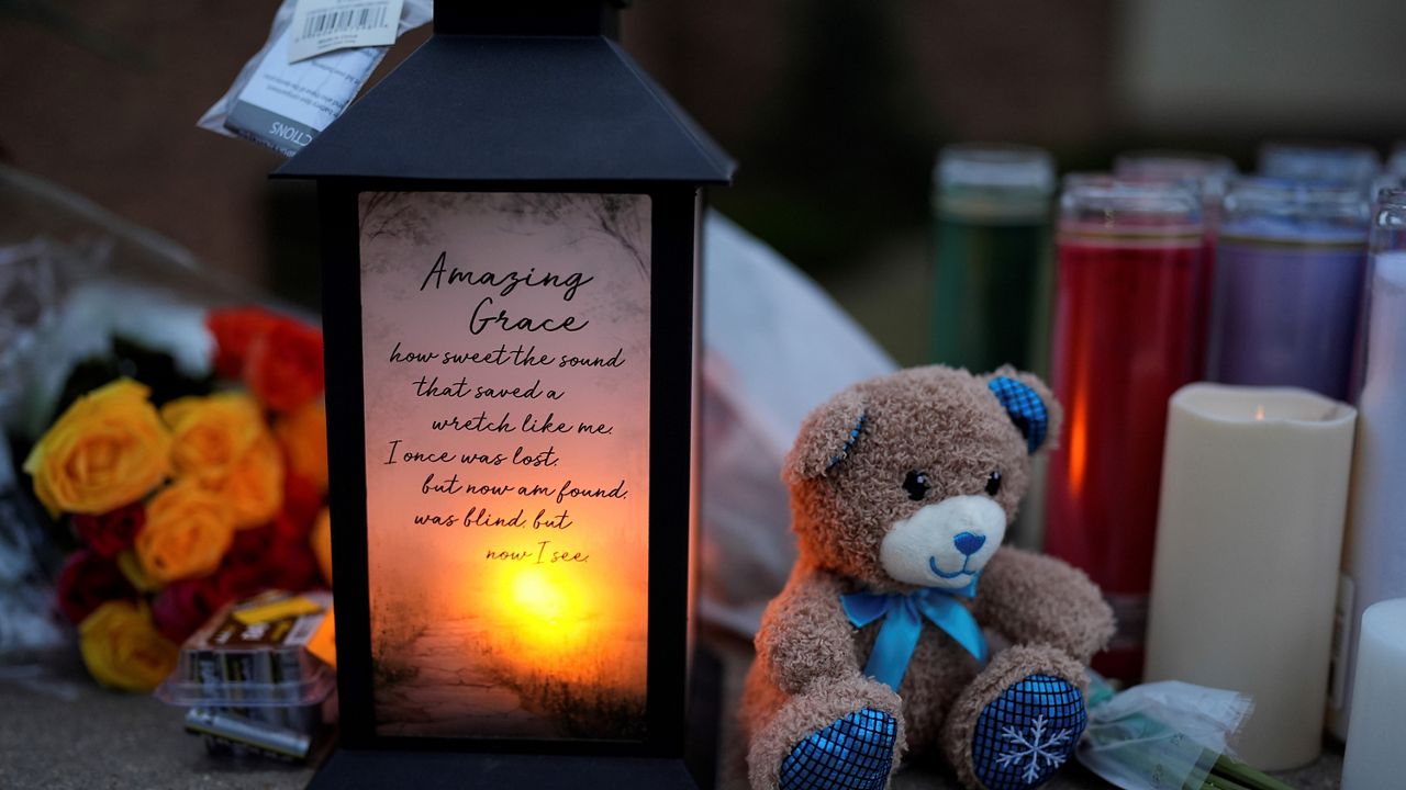 Flowers and candles are placed outside the Abundant Life Christian School 