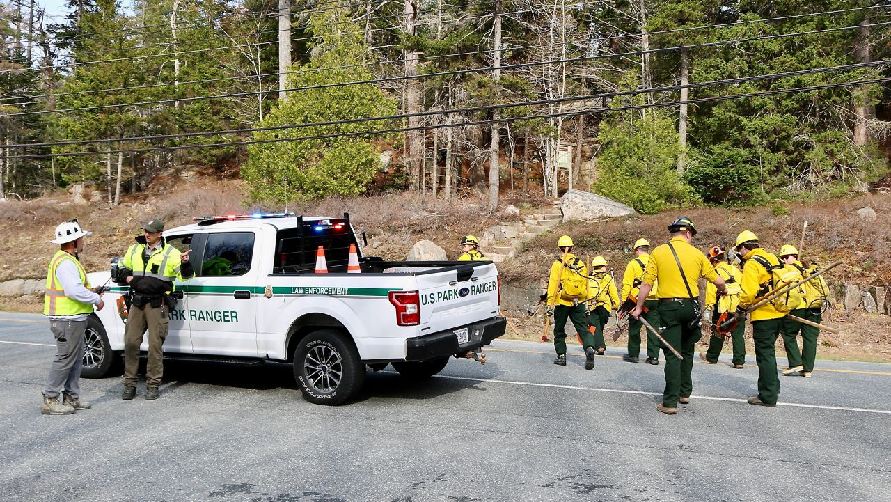 Park rangers and other responders start on the St. Sauveur trail to suppress fire. (National Park Service)