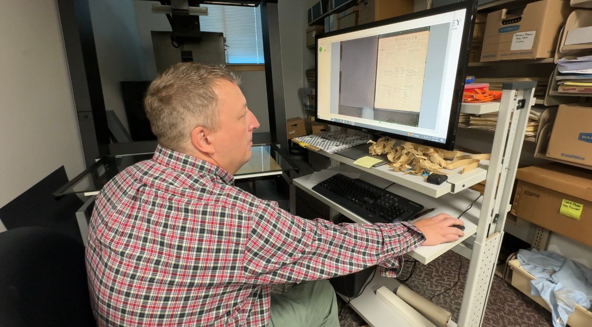 Adam Fisher, director of collections development and digital initiatives at the Maine State Library, shows some of the equipment the library uses to preserve historic newspapers. (Spectrum News/Susan Cover)