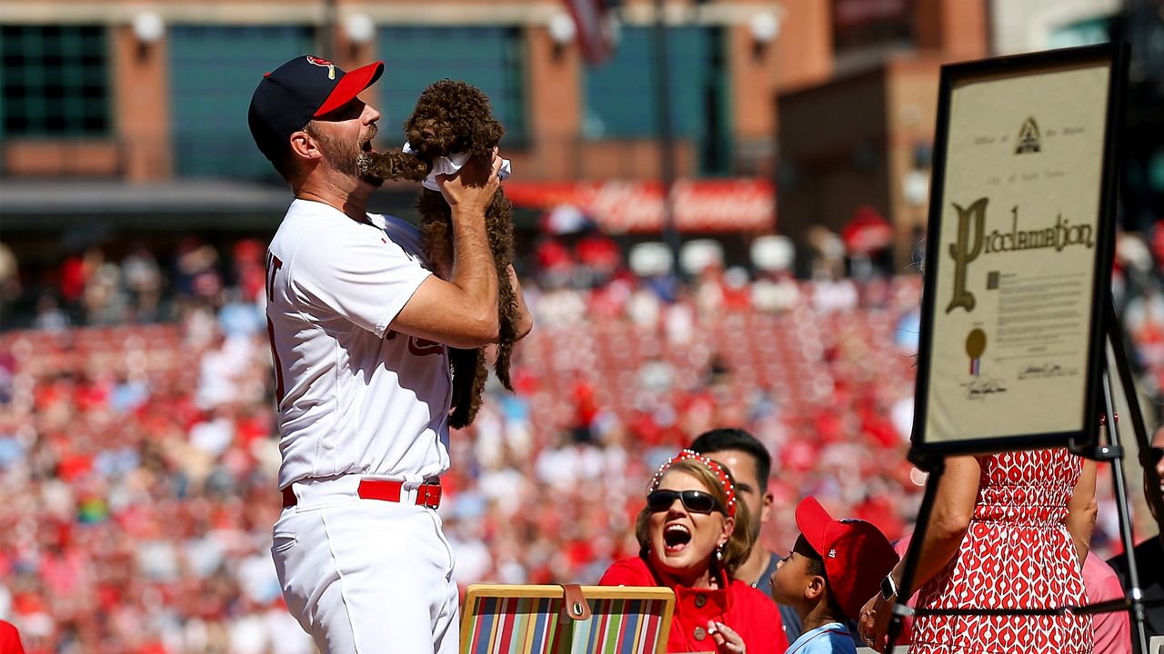 St. Louis Cardinals' Albert Pujols, watches as his son A.J., high