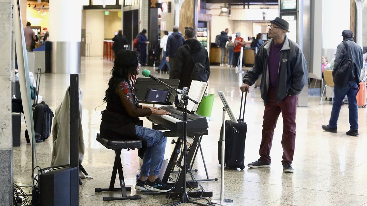 Roz McCommon performs at Seattle-Tacoma International Airport on November 26, 2024, in SeaTac, Wash. (AP Photo/Manuel Valdes)