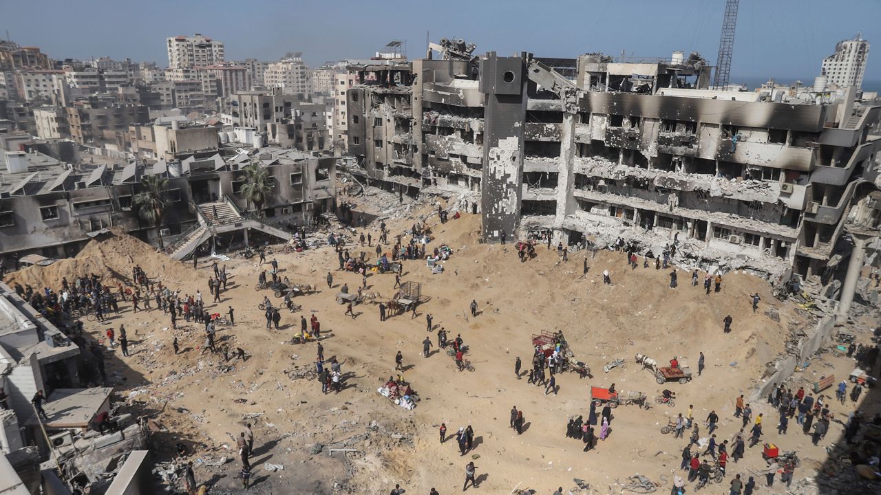 Palestinians walk through the destruction left by the Israeli air and ground offensive on the Gaza Strip near Shifa Hospital in Gaza City, Monday, April 1, 2024. (AP Photo/Mohammed Hajjar)