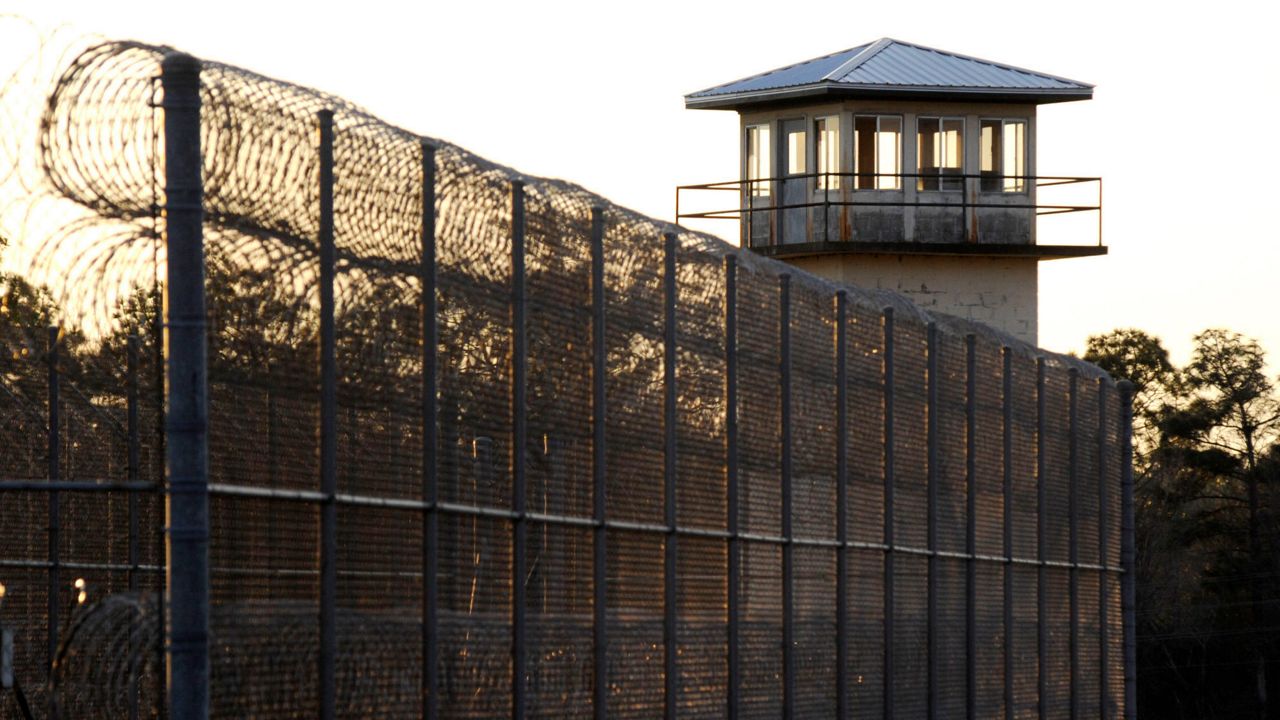 The sun sets behind Holman Prison in Atmore, Ala., on Jan. 27, 2022. (AP Photo/Jay Reeves, File)