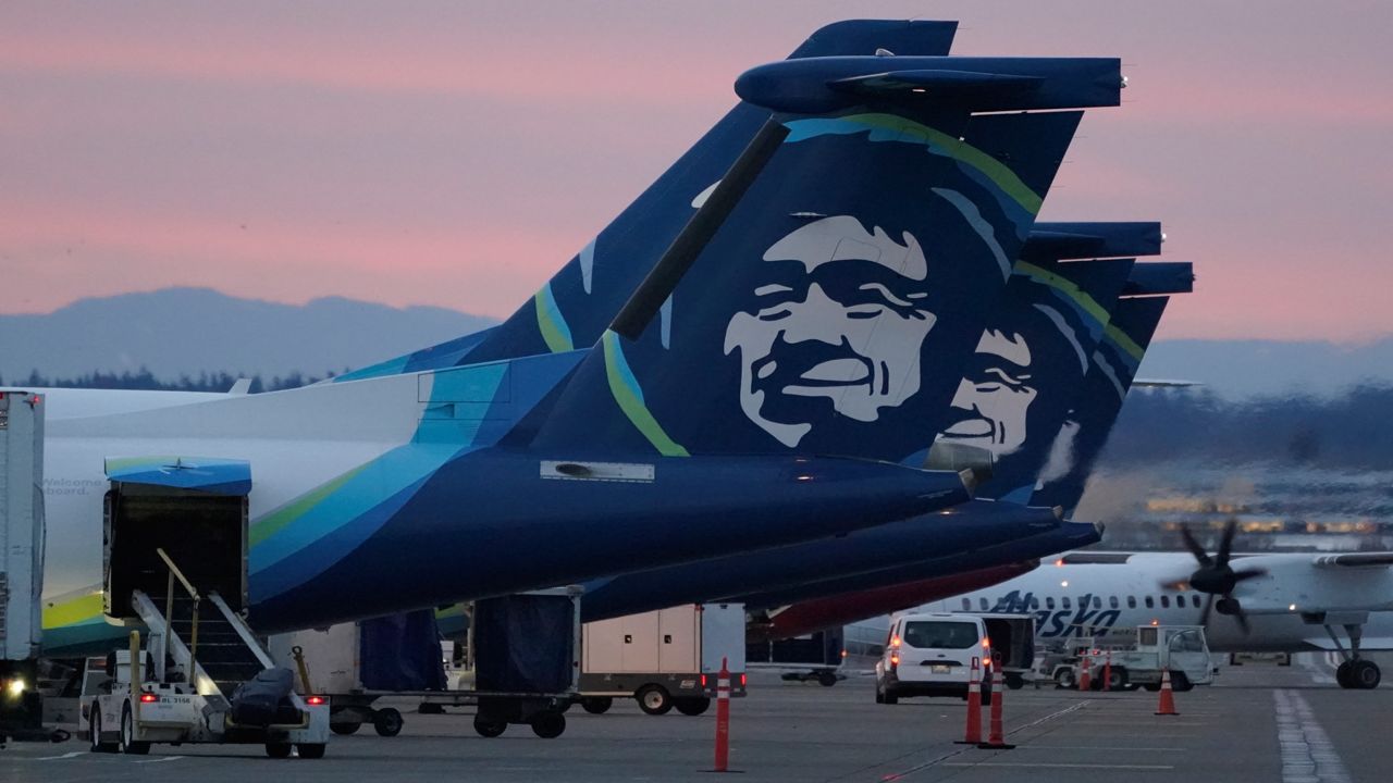 Alaska Airlines planes are shown parked at gates at sunrise, March 1, 2021, at Seattle-Tacoma International Airport in Seattle.