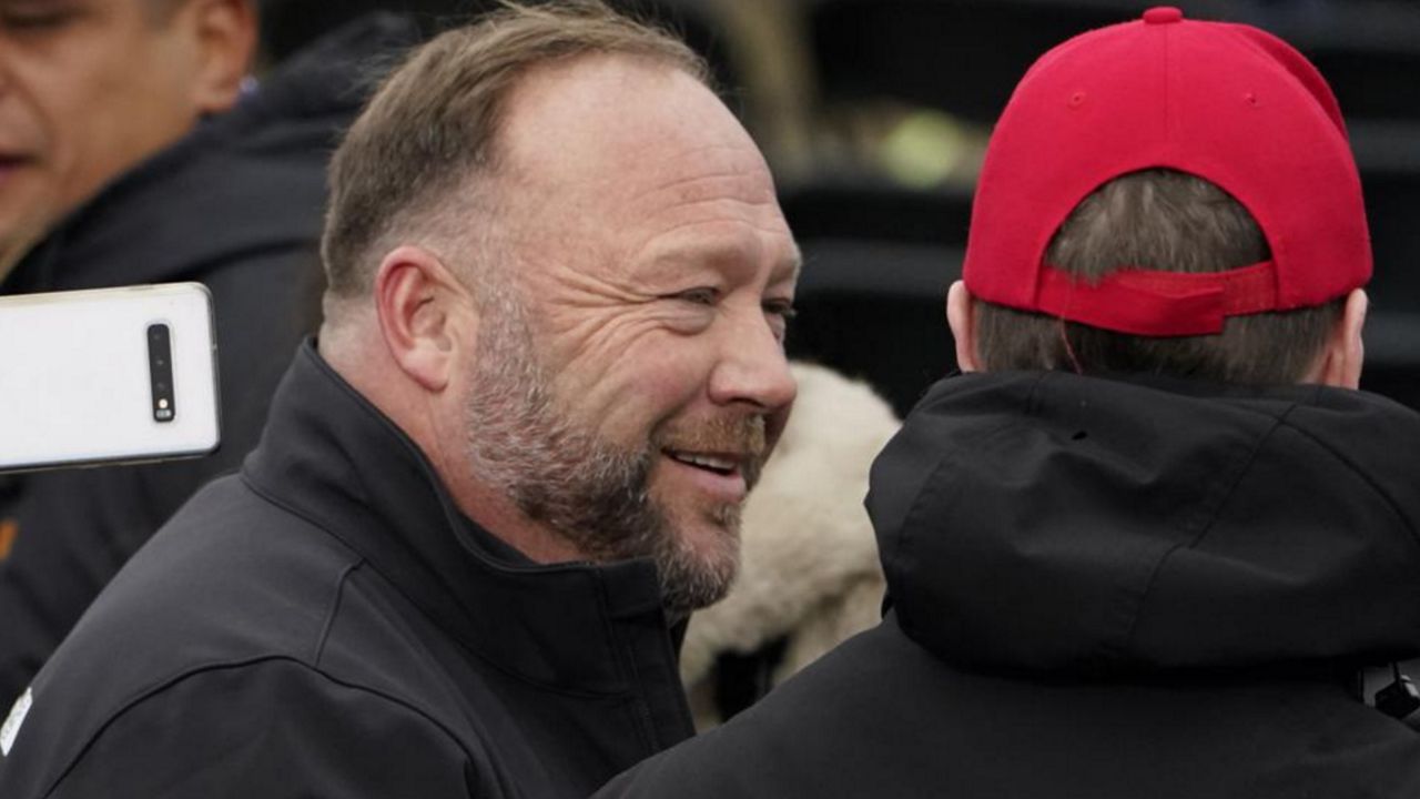 Alex Jones, left, attends a rally in support of President Donald Trump called the "Save America Rally," Wednesday, Jan. 6, 2021, in Washington. The wife of the conspiracy theorist was arrested Friday, Dec. 24, 2021, Christmas Eve on a domestic violence charge that the right-wing provocateur said stems from a “medication imbalance.” (AP Photo/Jacquelyn Martin, File)