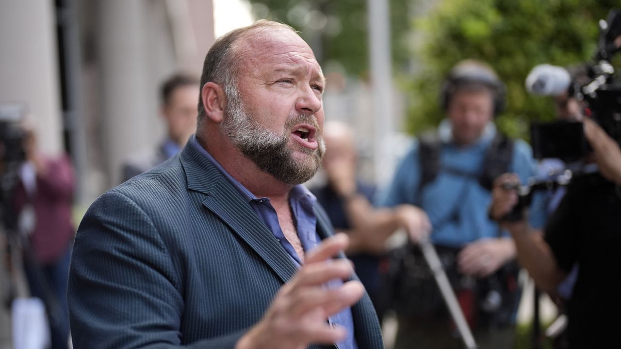 Right-wing conspiracy theorist Alex Jones speaks to the media after arriving at the federal courthouse for a hearing in front of a bankruptcy judge, Friday, June 14, 2024, in Houston. (AP Photo/David J. Phillip, File)