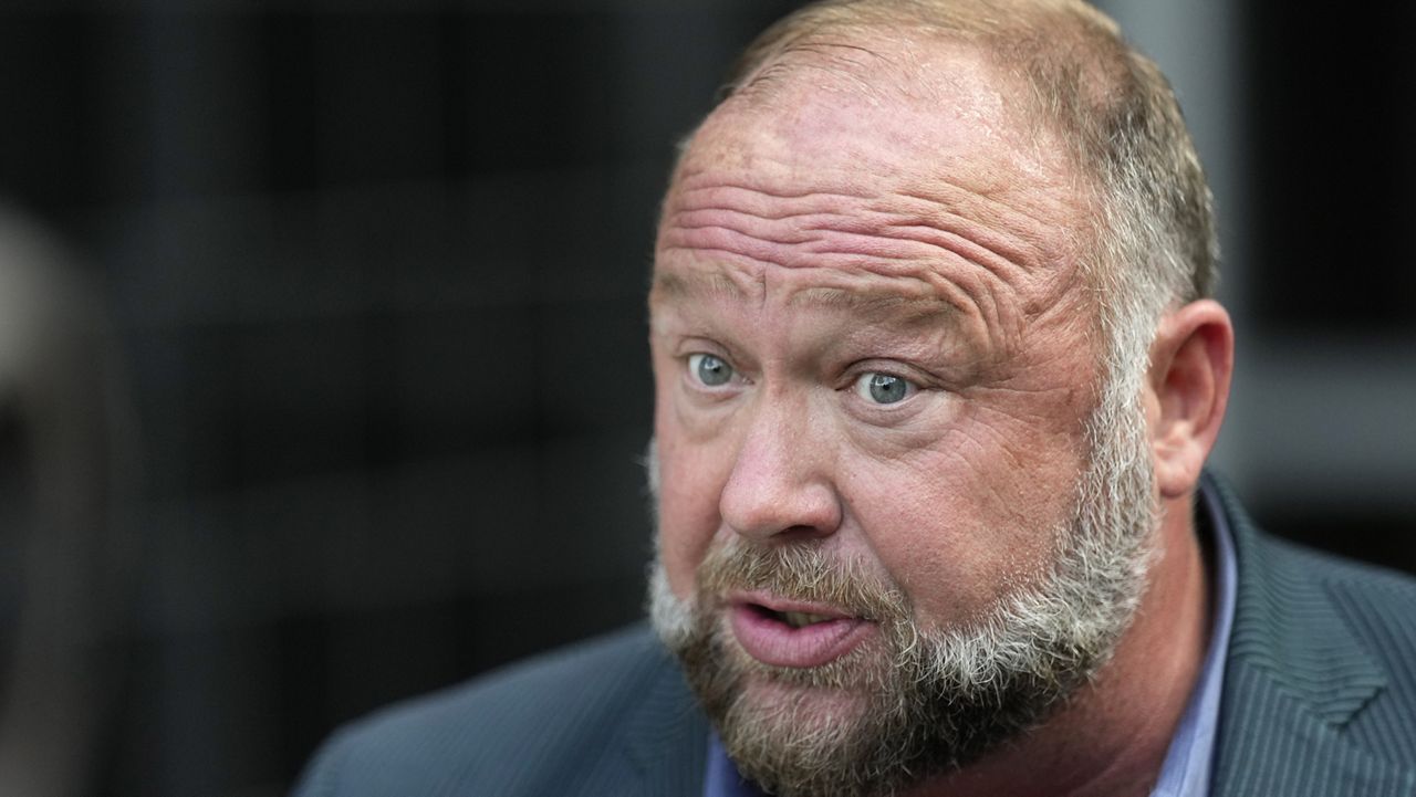 Right-wing conspiracy theorist Alex Jones speaks to the media after arriving at the federal courthouse for a hearing in front of a bankruptcy judge Friday, June 14, 2024, in Houston. (AP Photo/David J. Phillip, File)