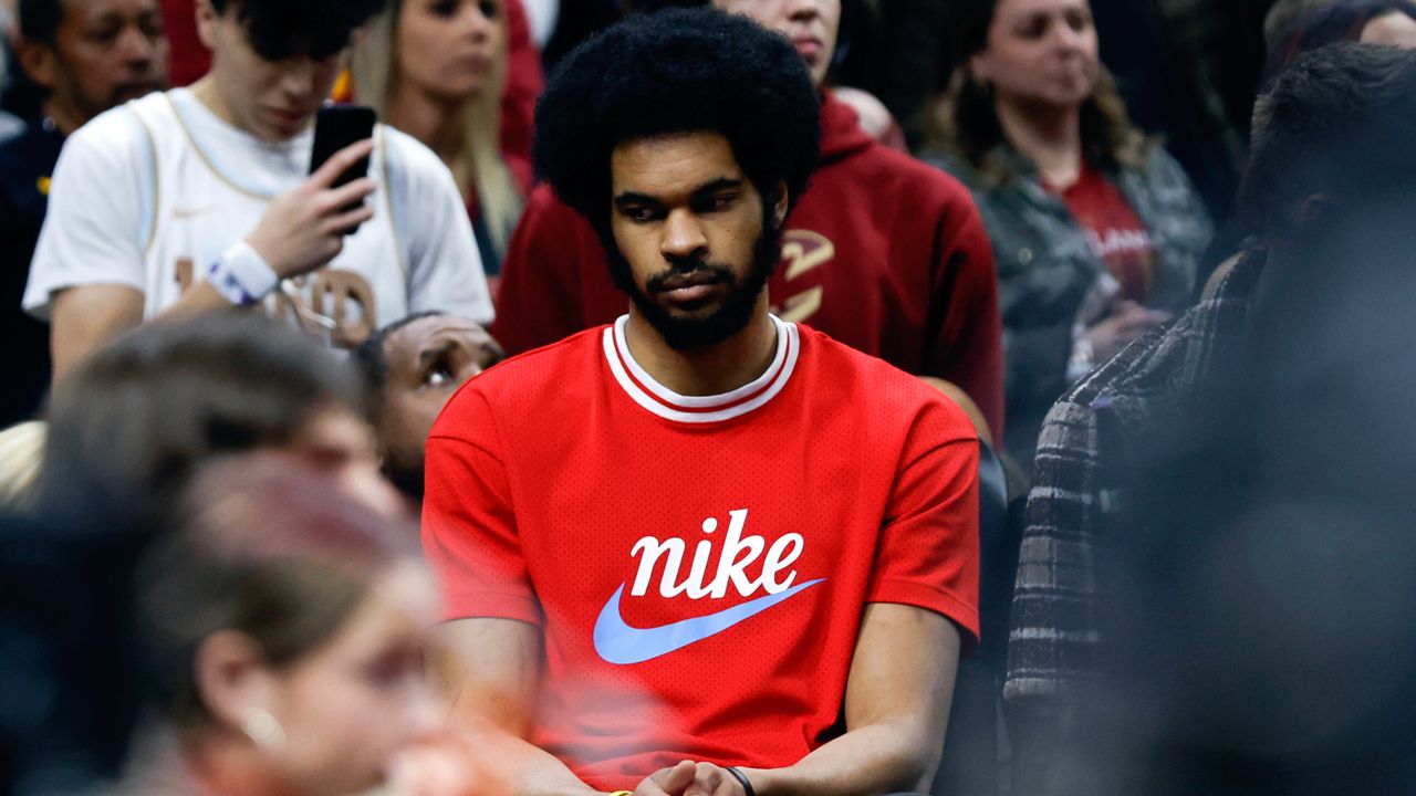 Injured Cleveland Cavaliers center Jarrett Allen sits on the bench during the second half of Game 5 of an NBA basketball first-round playoff series against the Orlando Magic, Tuesday, April 30, 2024, in Cleveland.