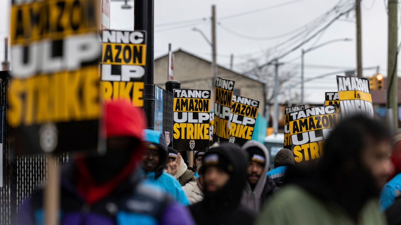 Amazon workers and members of the International Brotherhood of Teamsters picket in front of the Amazon fulfilment center in the Queens borough of in New York, on Friday, Dec. 20, 2024. (AP Photo/Stefan Jeremiah)