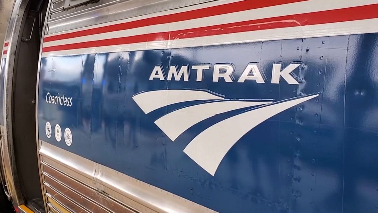 Close-up of Amtrak coach class car with door open