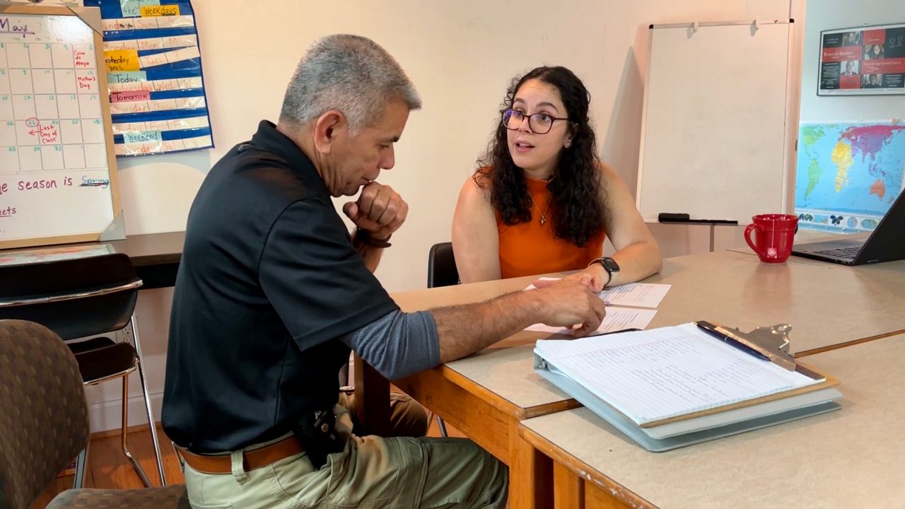 Andrea Melendez discusses basic computer skills with a student at Orange Literacy.
