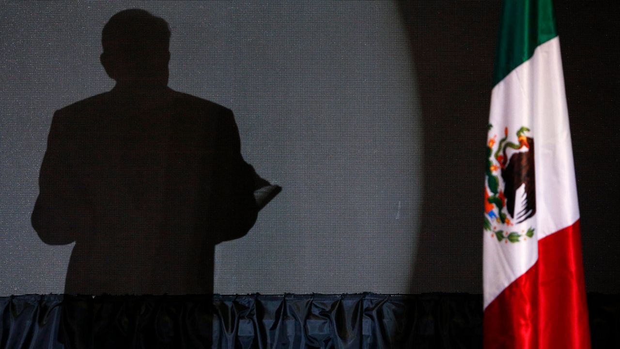 The shadow of presidential candidate Andres Manuel Lopez Obrador, founder of the ruling party, Morena, is cast on a screen as he gives his first victory speech at his campaign headquarters at the Hilton hotel in Mexico City, late July 1, 2018. (AP Photo/Marco Ugarte, File)