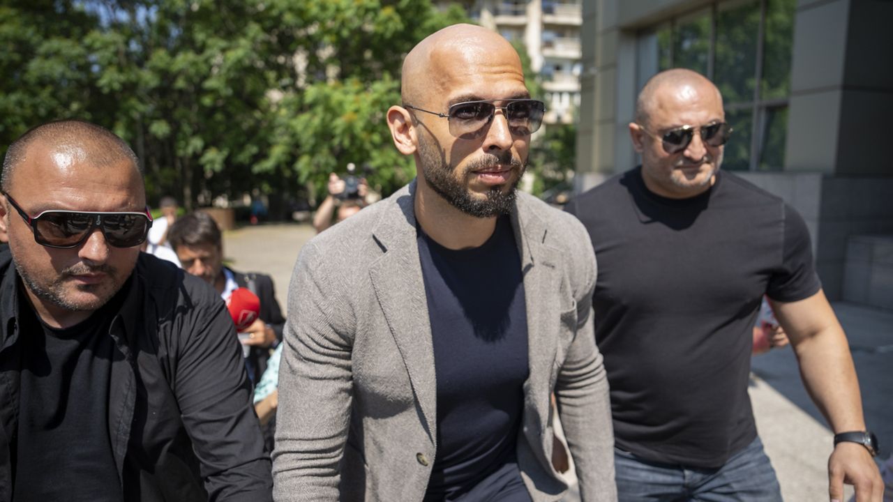 Andrew Tate walks between bodyguards as he arrives at the Bucharest Tribunal, in Bucharest, Romania, Wednesday, June 21, 2023. (AP Photo/Vadim Ghirda)