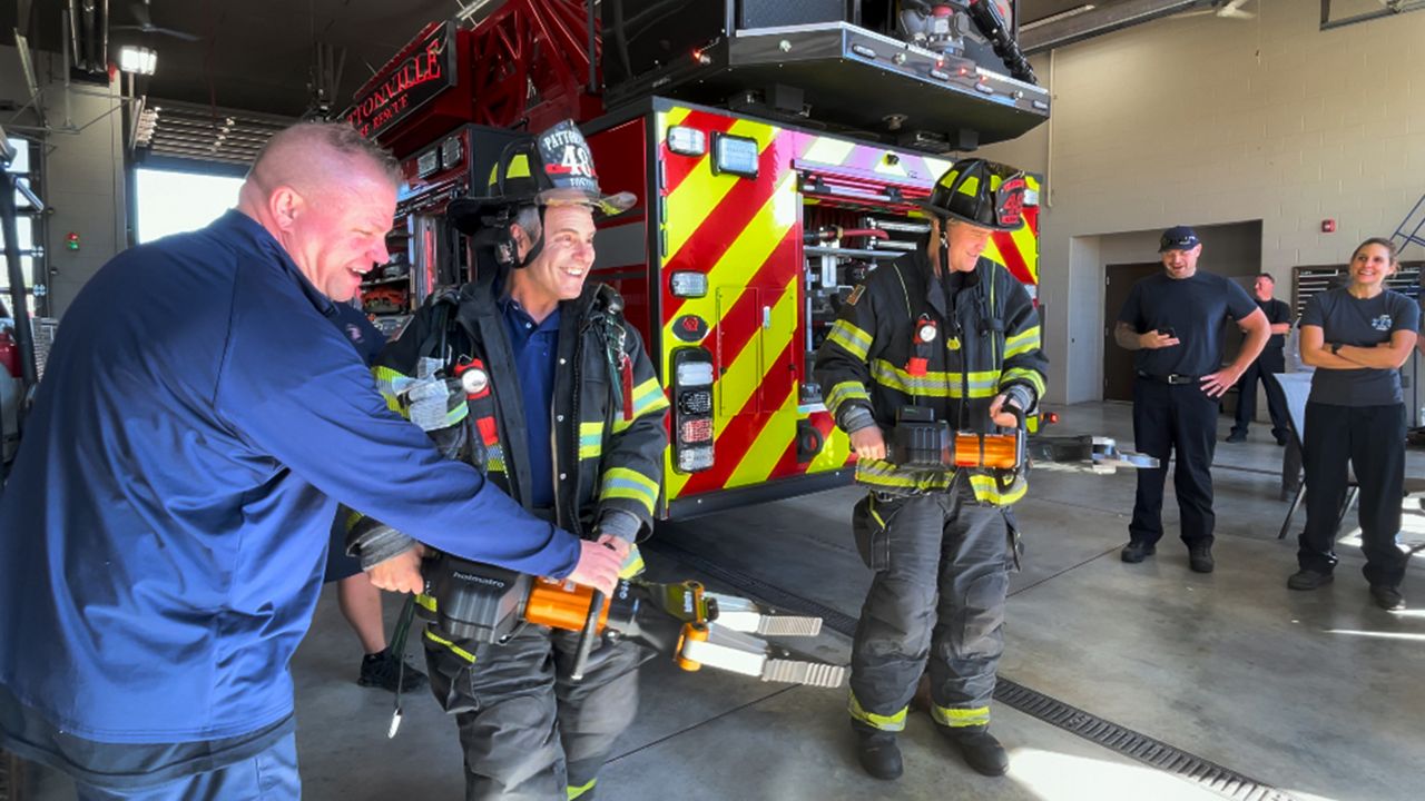 St. Louis native and celebrity Andy Cohen and Democratic senate candidate Lucas Kunce try on firefighter gear and test out equipment Friday afternoon at Pattonville Pattonville Fire Protection District State 3. (Spectrum News/Elizabeth Barmeier)