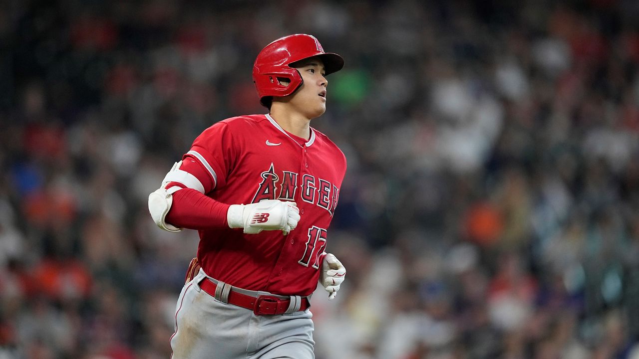 Los Angeles Angels' Shohei Ohtani runs up the first base line after hitting a single against the Houston Astros during the ninth inning of a baseball game Saturday, June 3, 2023, in Houston. (AP Photo/David J. Phillip)
