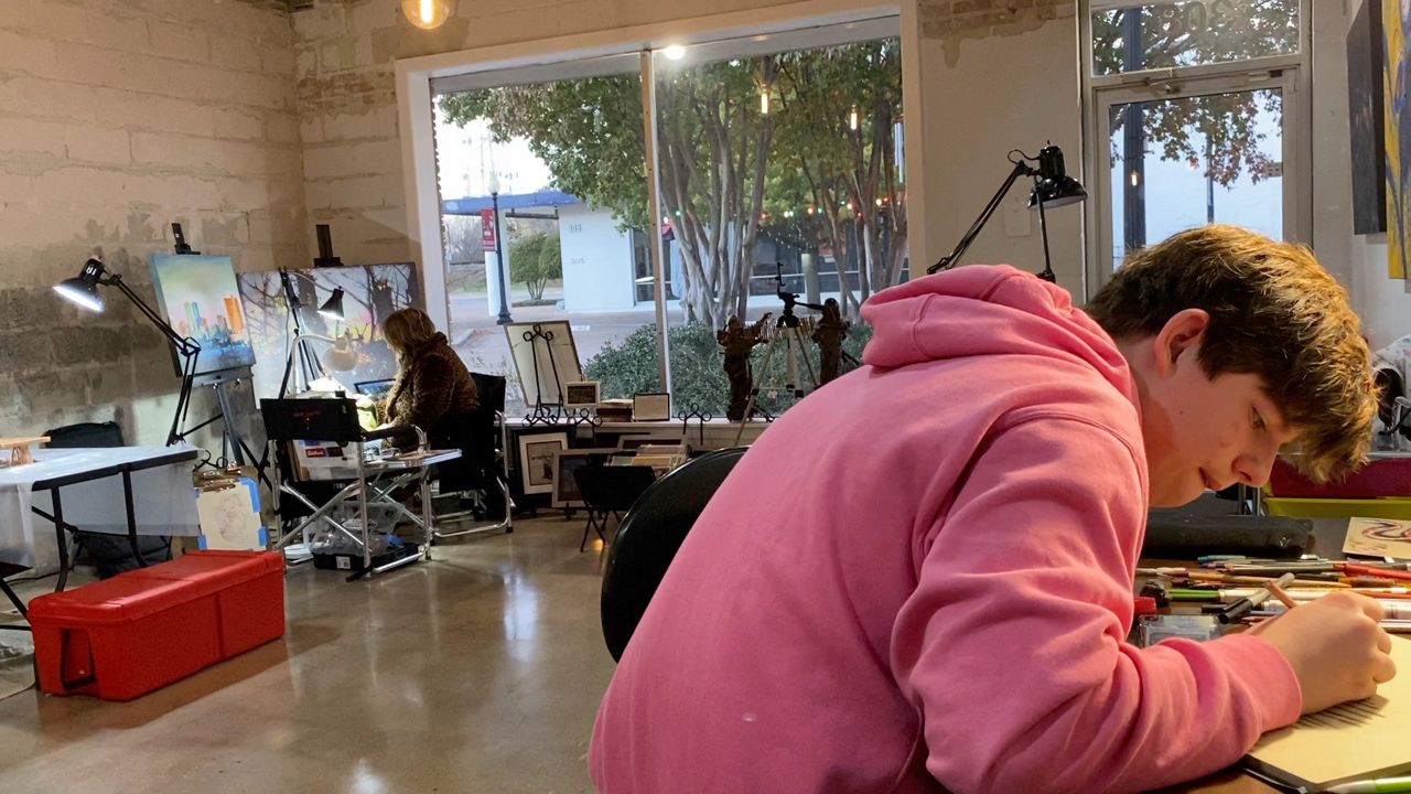 Artists Anthony Caddell-Adams and Keisha L. Smith working in the rented space area at Create Arlington. (Lupe Zapata/Spectrum News 1)