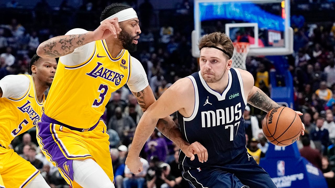 Dallas Mavericks guard Luka Doncic drives against Los Angeles Lakers forward Anthony Davis (3) during the first half of an NBA basketball game in Dallas, Tuesday, Dec. 12, 2023. 