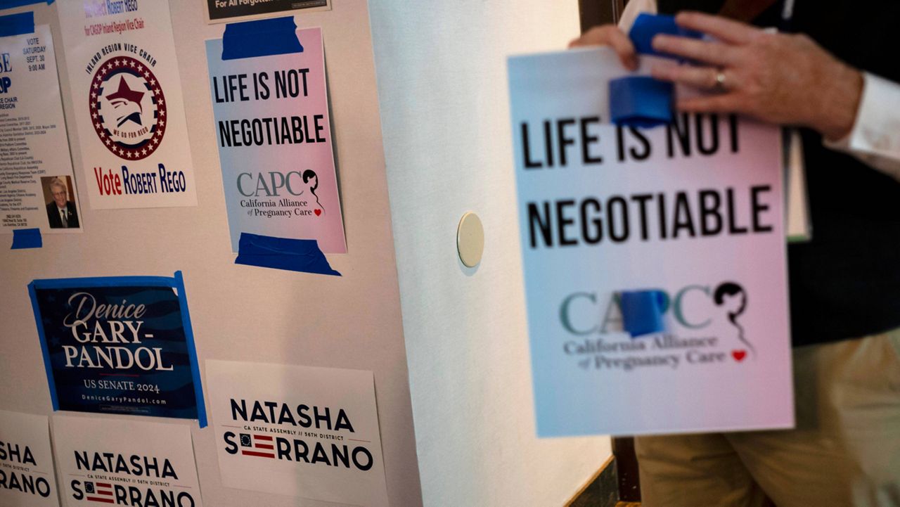 An Anti-abortion supporter holds a sign at the California Republican Party Convention in Anaheim, Calif., Sept. 30, 2023. (AP Photo/Jae C. Hong, File)
