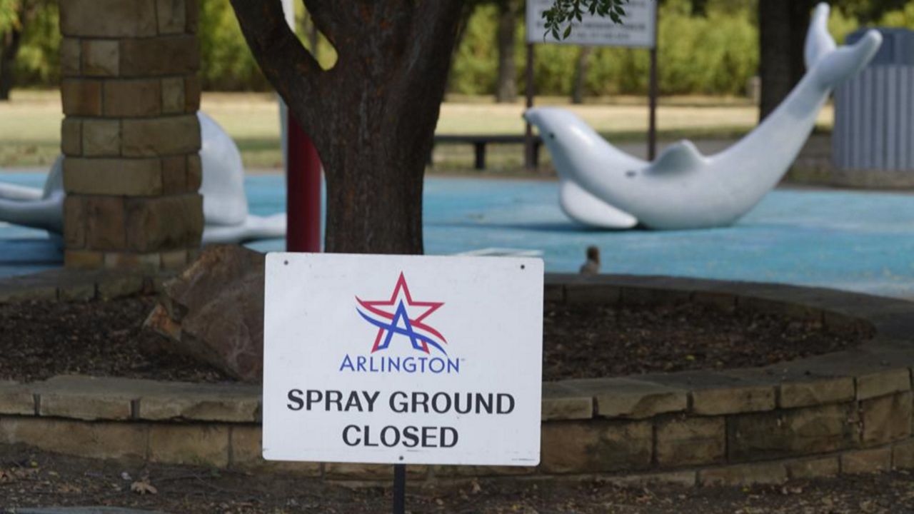 A sign states the splash pad is closed at Don Misenhimer Park where child was infected with a rare brain-eating amoeba in Arlington, Texas, Sept. 28, 2021. The Arlington City Council approved a $250,000 settlement March 29, 2022, with the parents of Bakari Williams. He died Sept. 11 after being hospitalized with primary amebic meningoencephalitis, a rare and typically fatal infection caused by the naegleria fowleri amoeba. (AP Photo/LM Otero, File)