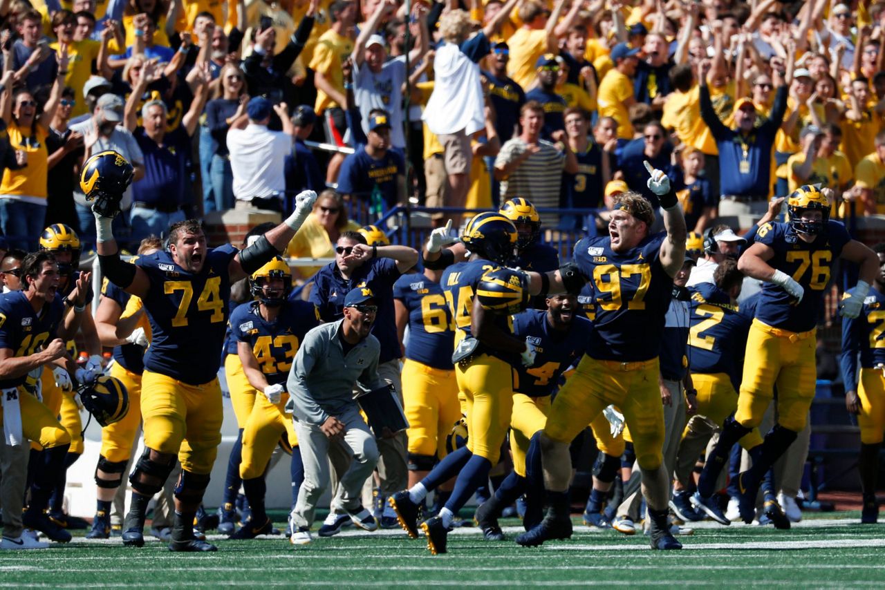 Michigan defensive back Ambry Thomas (1) tries to rip the ball