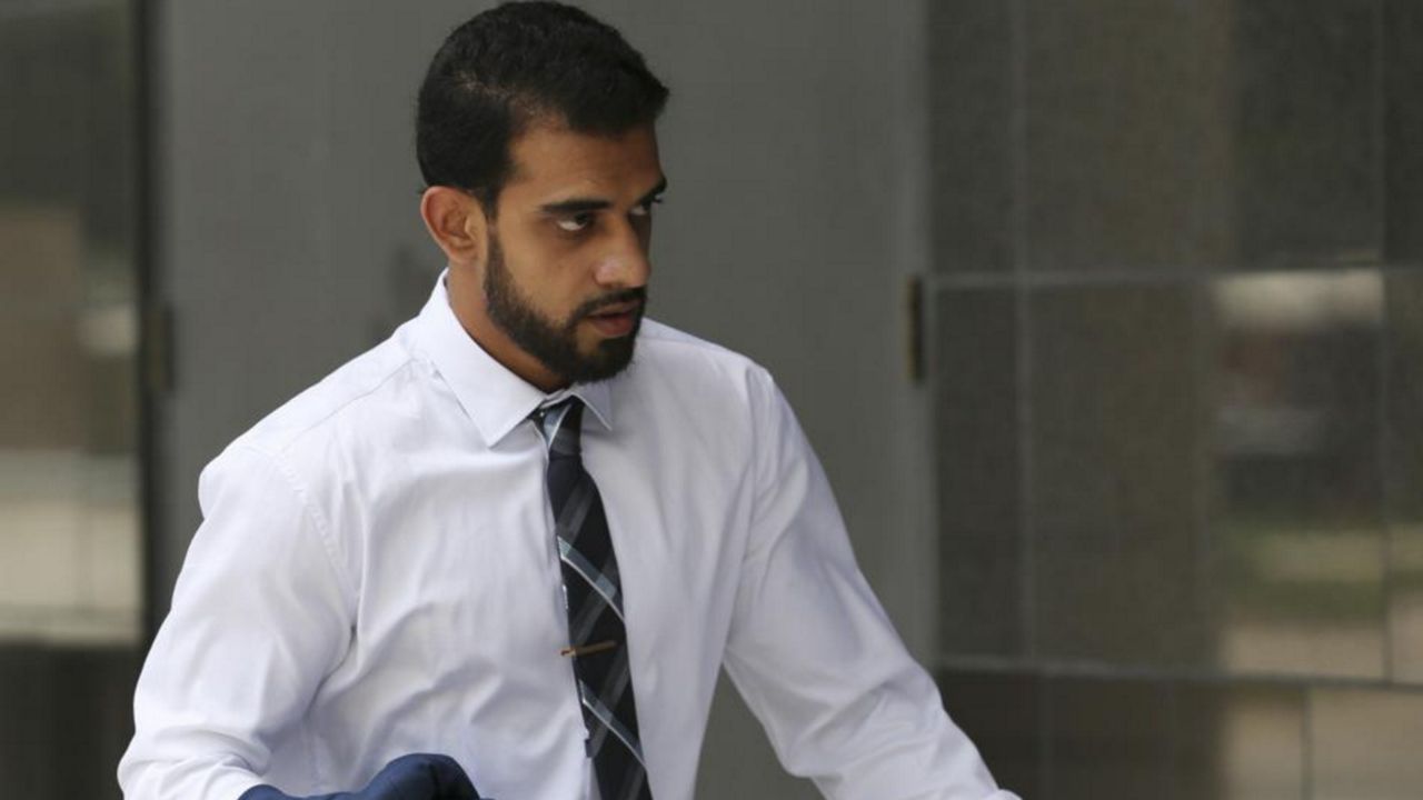 Asher Abid Khan, of Spring, walks toward the United States District Courthouse for his sentencing before a federal court judge on Monday, June 25, 2018, in Houston. Khan who was convicted of providing material support to the Islamic State group was sentenced Wednesday, Dec. 22, 2021, to 12 years in federal prison after the government appealed his previous sentence, saying it was too lenient. U.S. District Judge Charles R. Eskridge in Houston sentenced Khan, 27, to also serve 15 years of supervised release, prosecutors said. (Yi-Chin Lee/Houston Chronicle via AP)