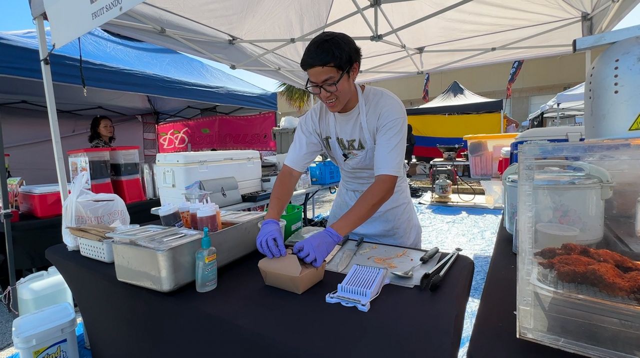 Nam’s Sandos food stand owner Bryan Truong is one of the many participants of Mega Night Market. (Spectrum Bay News 9)