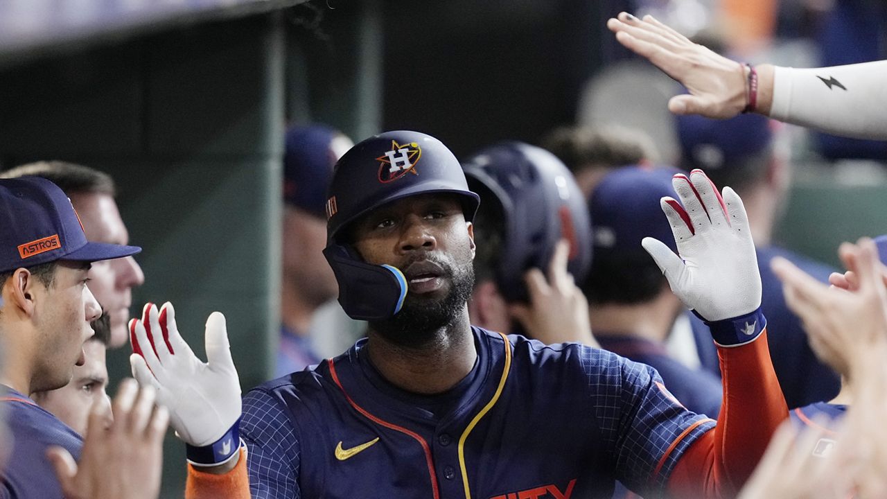 Houston Astros' Jason Heyward is congratulated in the dugout after hitting solo home run during the eighth inning of a baseball game against the Seattle Mariners, Monday, Sept. 23, 2024, in Houston. (AP Photo/Kevin M. Cox)