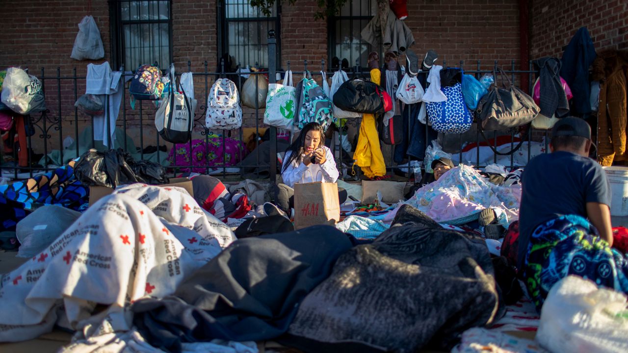 In this photo taken on Friday, May 5, 2023, Venezuelan migrant Genesis Rodriguez applies make up after waking up at the campsite outside Sacred Heart Church in downtown El Paso, Texas. As confusion explodes in El Paso, one of the busiest illegal crossings points for migrants seeking to flee poverty and political strife, faith leaders continue to provide shelter, legal advice and prayer. (AP Photo/Andres Leighton)