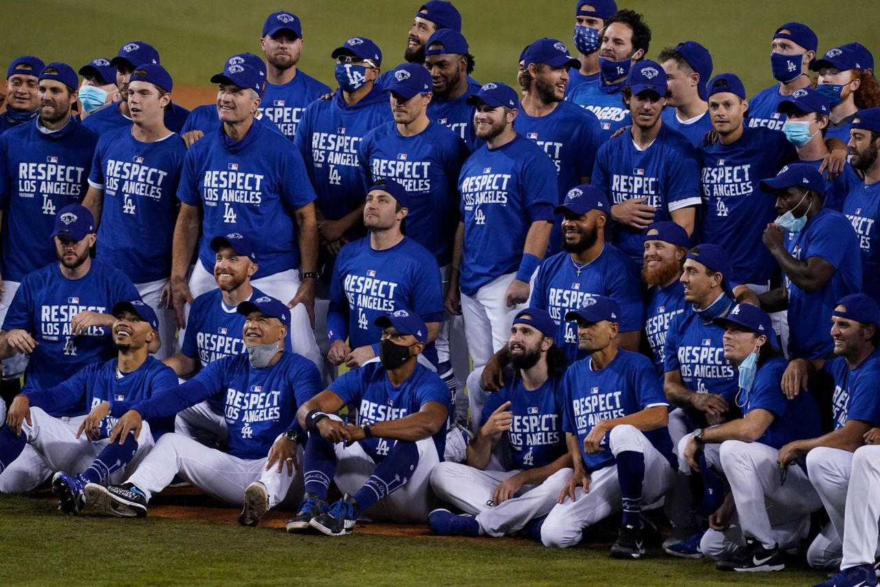 Dodgers clinch NL's top seed, West title with win over A's