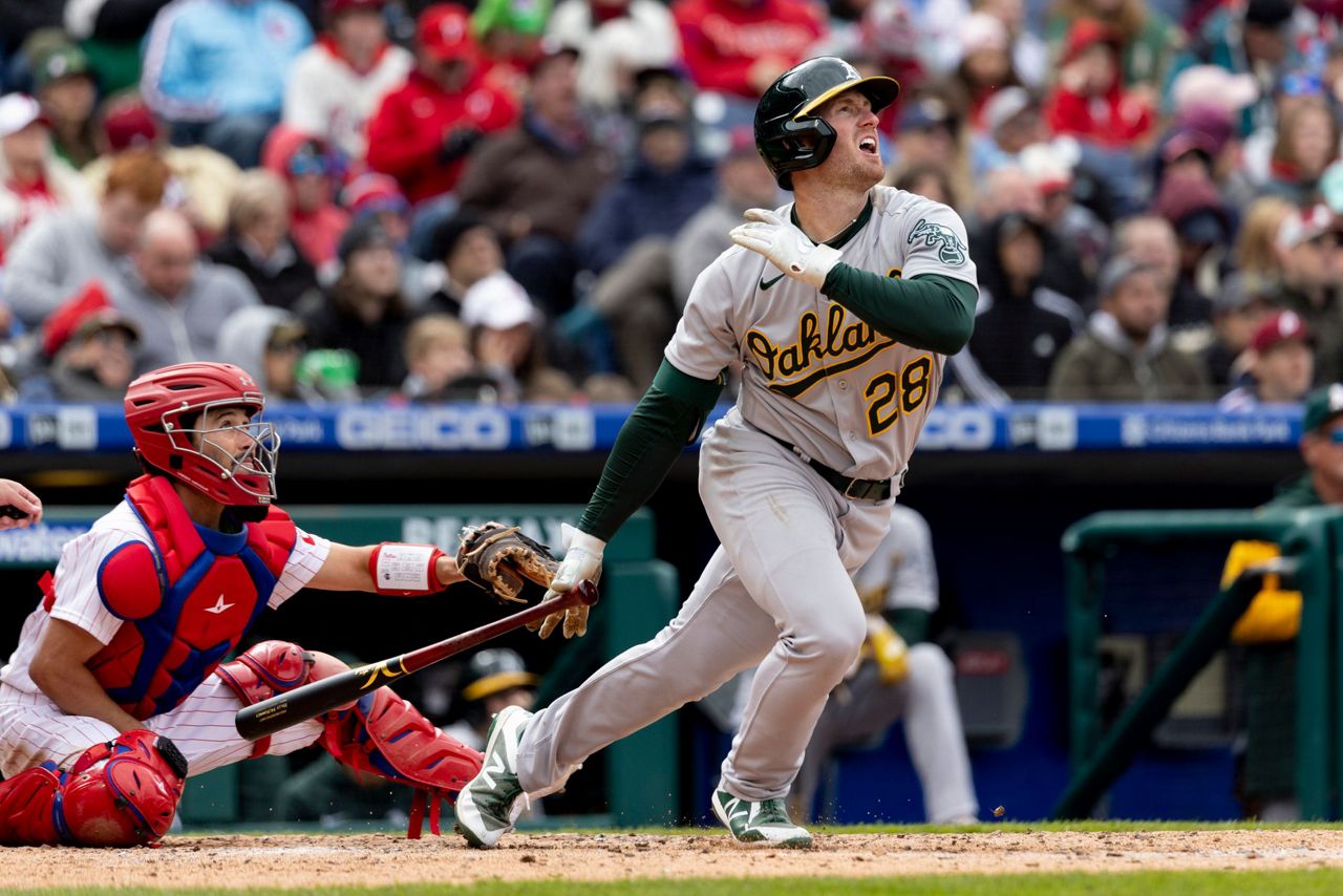 Philadelphia Phillies' Cristian Pache bunts for a single during