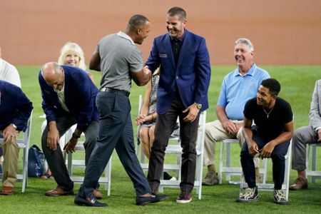 Former Texas Rangers player, Adrian Beltre (left) waves to the