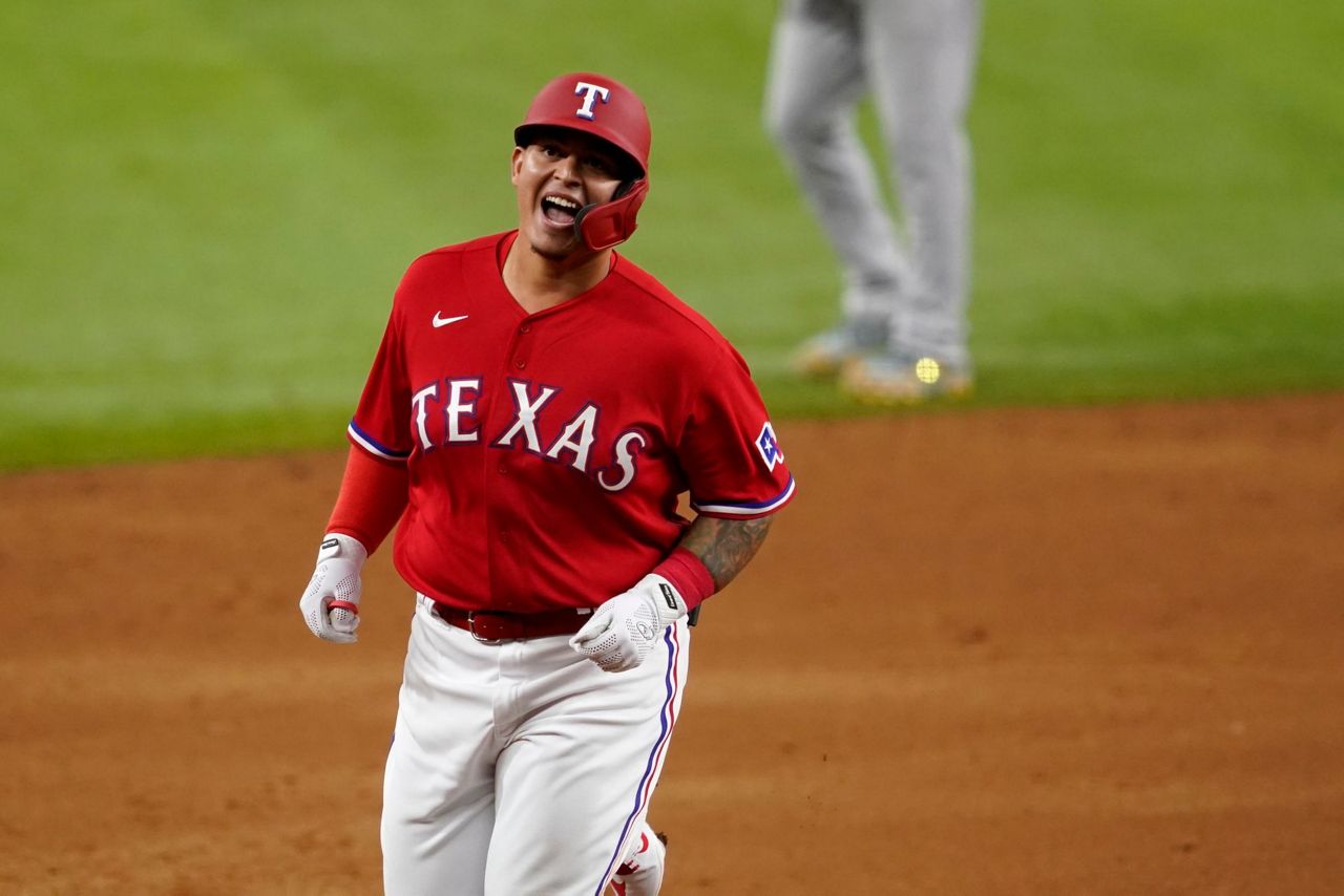 Texas Rangers' Elvis Andrus smiles as he looks on at play during a