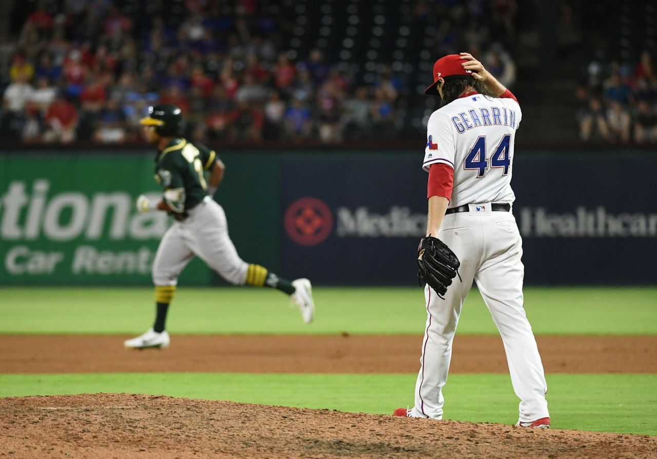 Davis hits 2 more HRs, A's rally again to beat Rangers 6-5