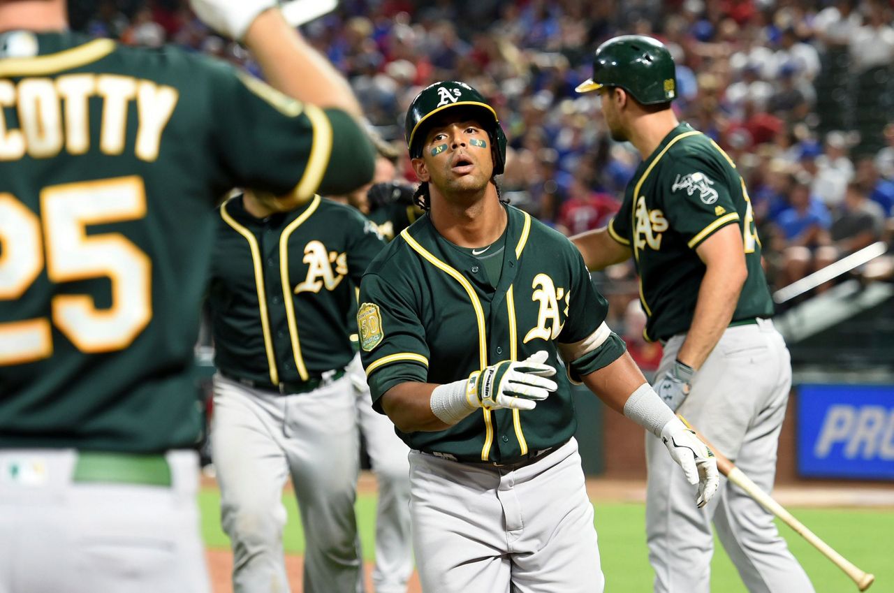 Davis hits 2 more HRs, A's rally again to beat Rangers 6-5