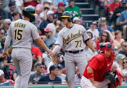 Rafael Devers of the Boston Red Sox is congratulated in the dugout