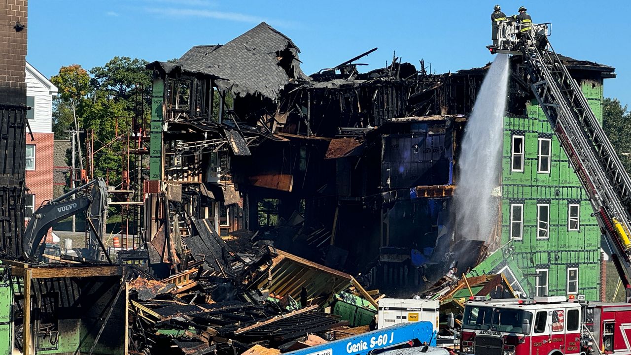  Crews were at the scene of the Auburn apartment complex construction site putting out hot spots and assessing the extent of the damage. (Spectrum News/Matthew Jaroncyk)