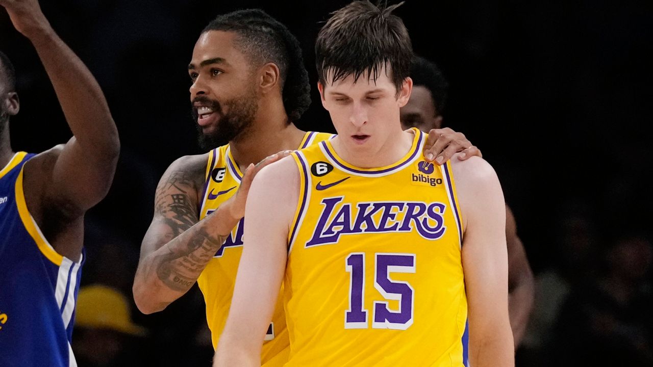 Los Angeles Lakers guard Austin Reaves (15) is hugged by guard D'Angelo Russell after Reaves scored during the first half in Game 6 of an NBA basketball Western Conference semifinal series against the Golden State Warriors Friday, May 12, 2023, in Los Angeles. (AP Photo/Ashley Landis)