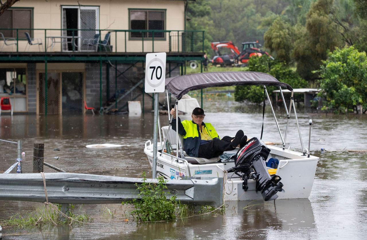 Australian east coast rain to ease but flooding continues