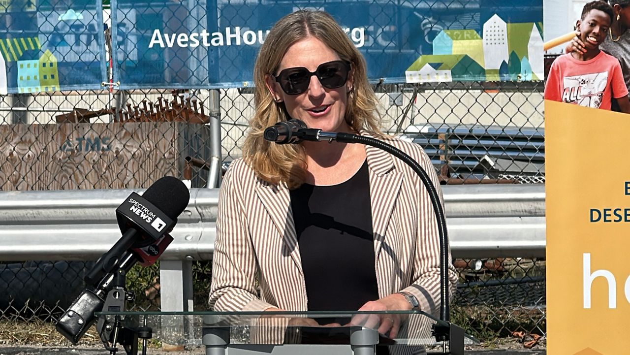 Jennifer Hawkins, president and CEO of Avesta Housing, speaks at a ceremony celebrating a new housing project under construction in Portland on Tuesday. (Spectrum News/Sean Murphy)