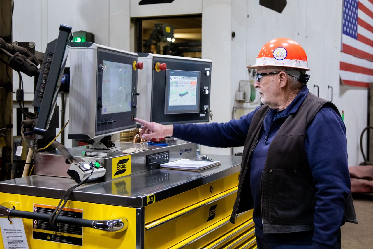 Les Waltz, a 59-year employee of Bath Iron Works, was selected to activate the burning machine that cut the first sheet of steel for the future USS John E. Kilmer. Waltz started in Structural Fabrication and currently is a dispatcher for the transportation team. (Bath Iron Works)