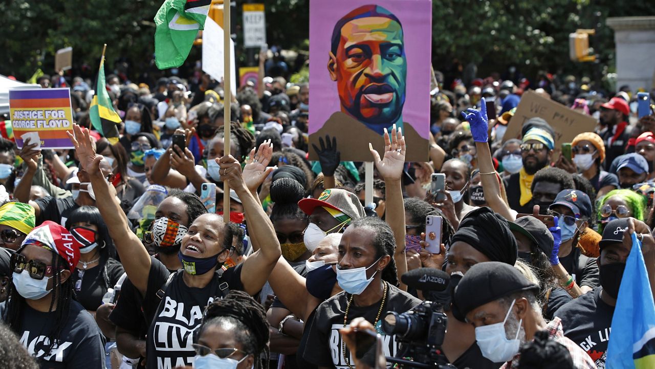 FILE - In this June 14, 2020, file photo, people participate in a Caribbean-led Black Lives Matter rally at Brooklyn's Grand Army Plaza in New York. (AP Photo/Kathy Willen, File)