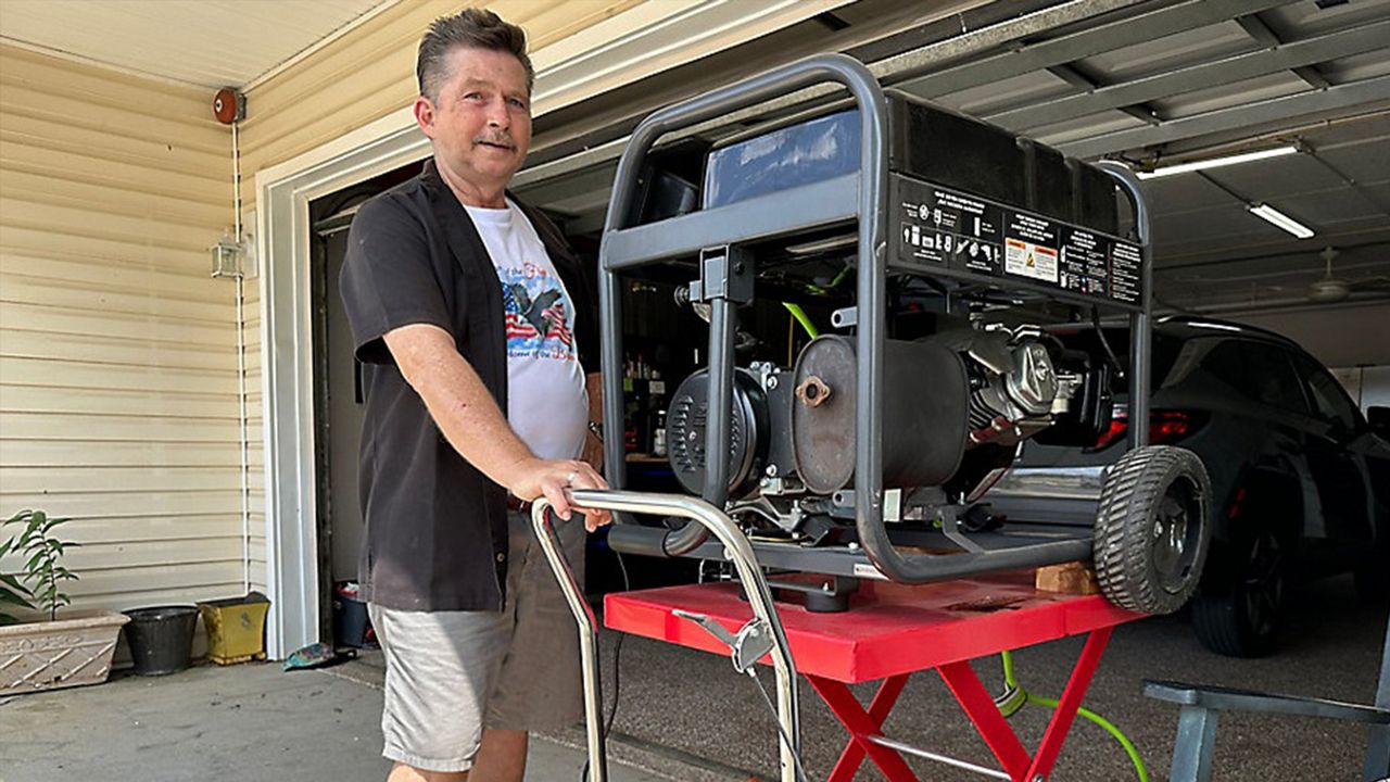 St. Pete Beach resident Rick Hilber testing his generator and lift ahead of hurricane season. (Spectrum News/Erica Riggins)