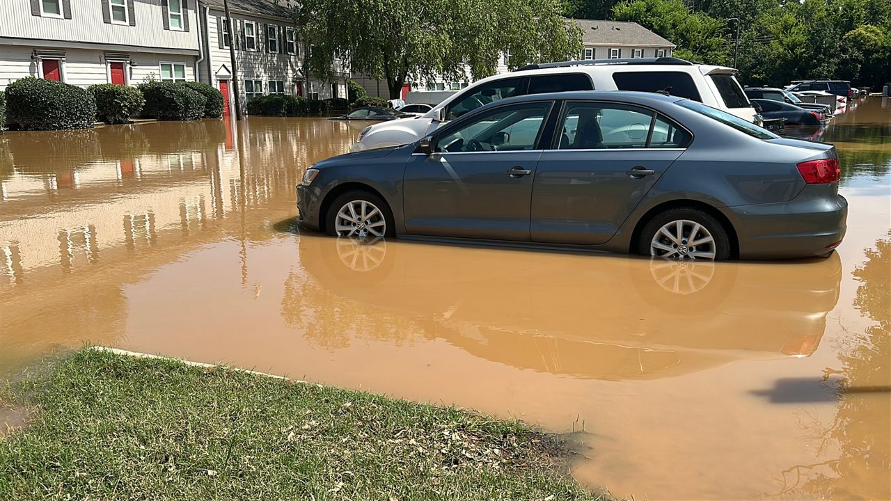 Cars in a flooded parking lot outside an apartment complex in Durham County (Spectrum News 1/Patrick Thomas) 